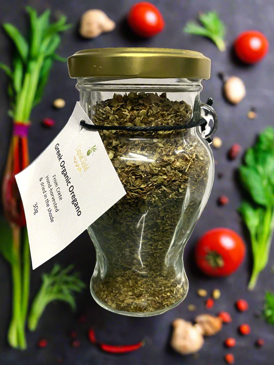 Cretan organic oregano in glass amphora jar, with fresh salad