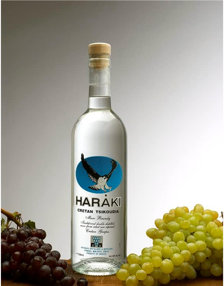 Haraki bottle with grapes on a gray background