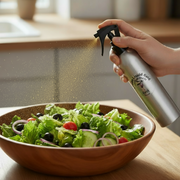 Cretan liquid gold organic extra virgin olive oil being sprayed from an aluminium bottle onto a salad