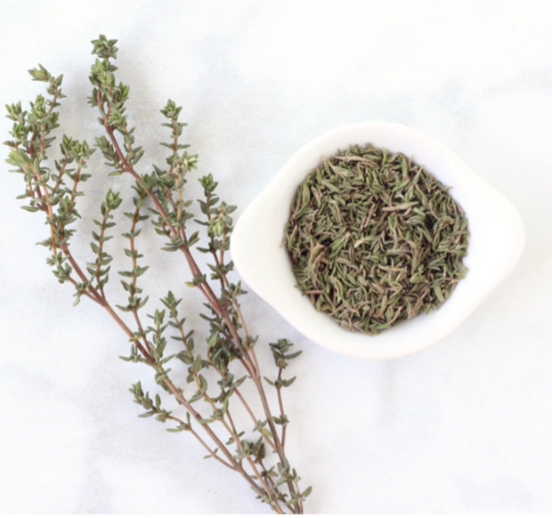 Greek wild thyme from the mountains of Crete, dried in the shade, showing a branch with leaves and dried thyme in a bowl