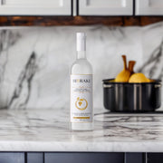 Organic Cretan Raki "BioRaki" or tsikoudia, also known as Tsipouro elsewhere in Greece; a grappa like Greek spirit made from double distillation of g=indigenous grape marc; 38% alcohol bol. 700ml bottle, shown on marble table top with fruit bowl